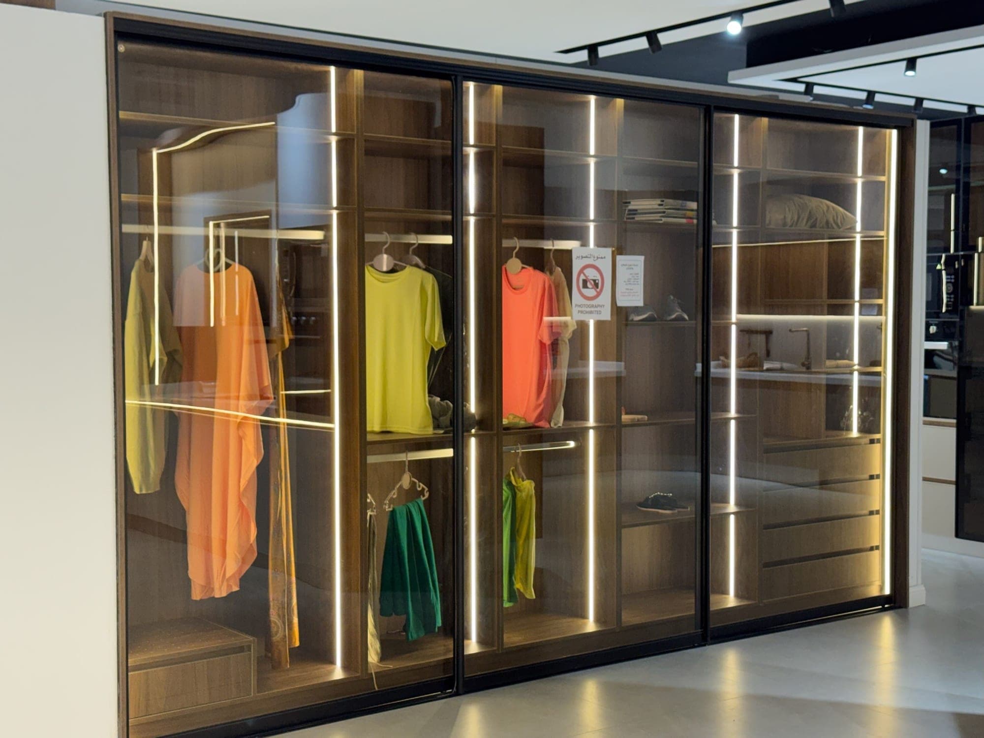 Glass-door wardrobe with interior lighting — built by Blum for Kitchens