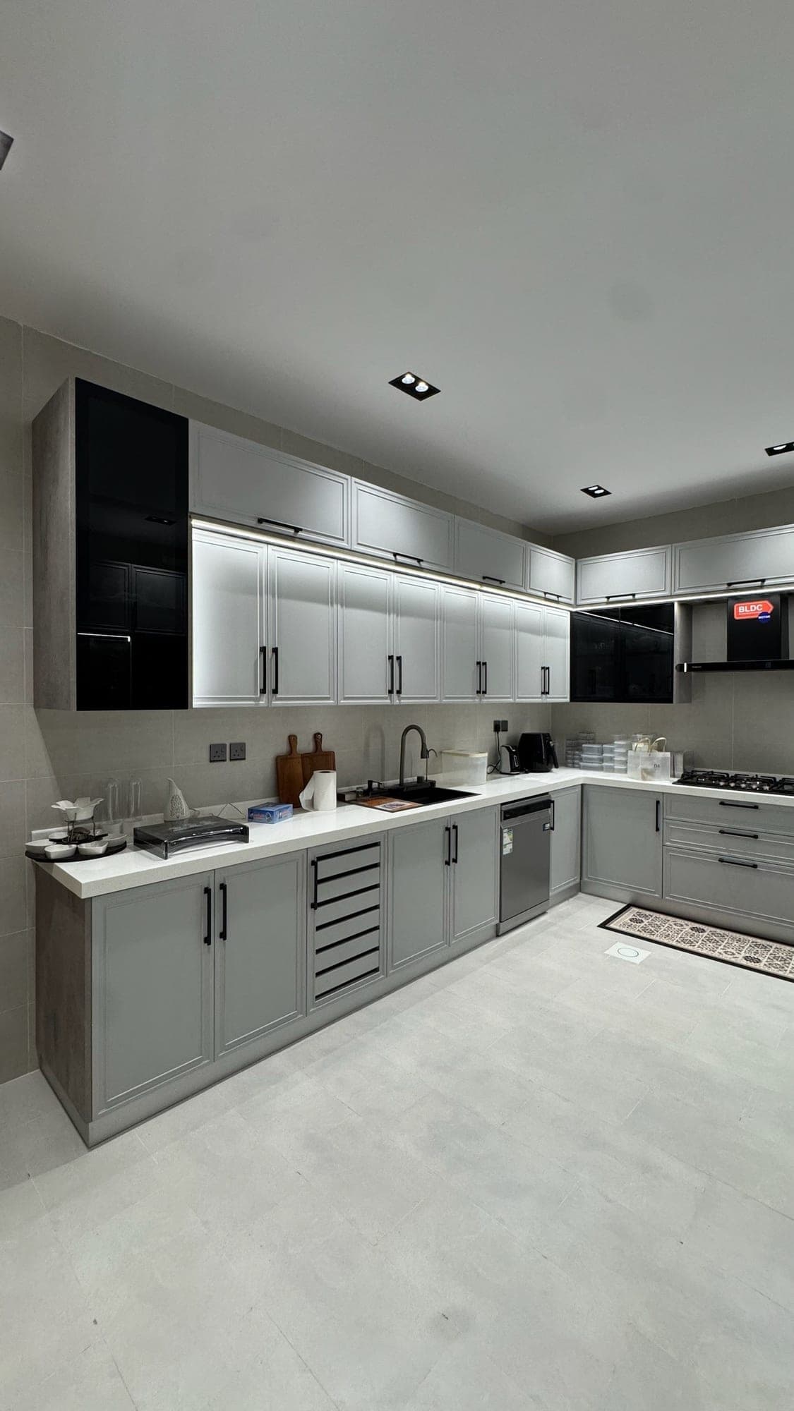 Grey U-shaped kitchen with ceiling lighting — built by Blum for Kitchens